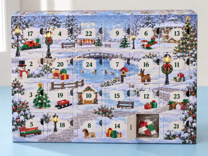 An illustrated building-block Advent calendar with shuffled numbers and a sealed pack of bricks visible behind door 1.