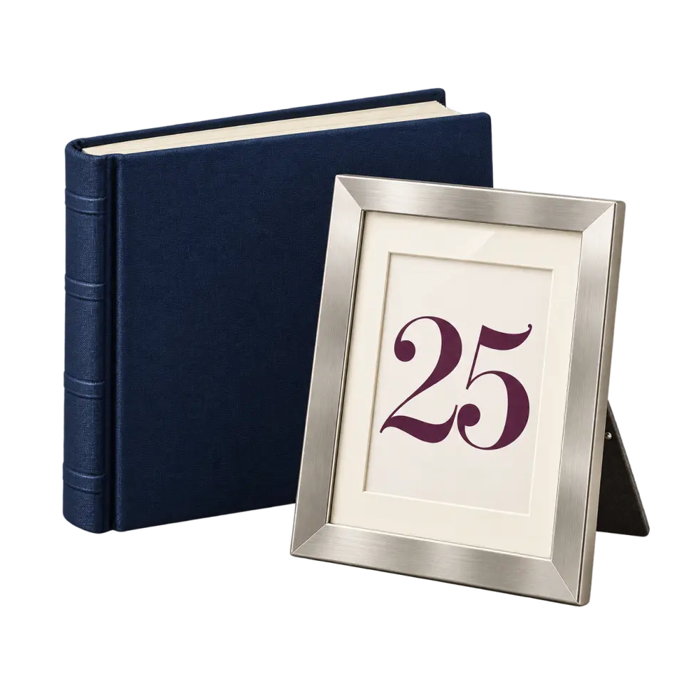 A silver-colored picture frame displaying 25 beside a closed navy photo album.