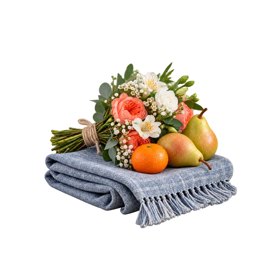 A hand-tied coral and white bouquet with pears and an orange resting on folded blue cloth.